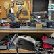 A messy garage with a bunch of motorcycle parts scattered about.